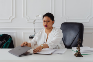  A local immigration lawyer opening a laptop on their desk